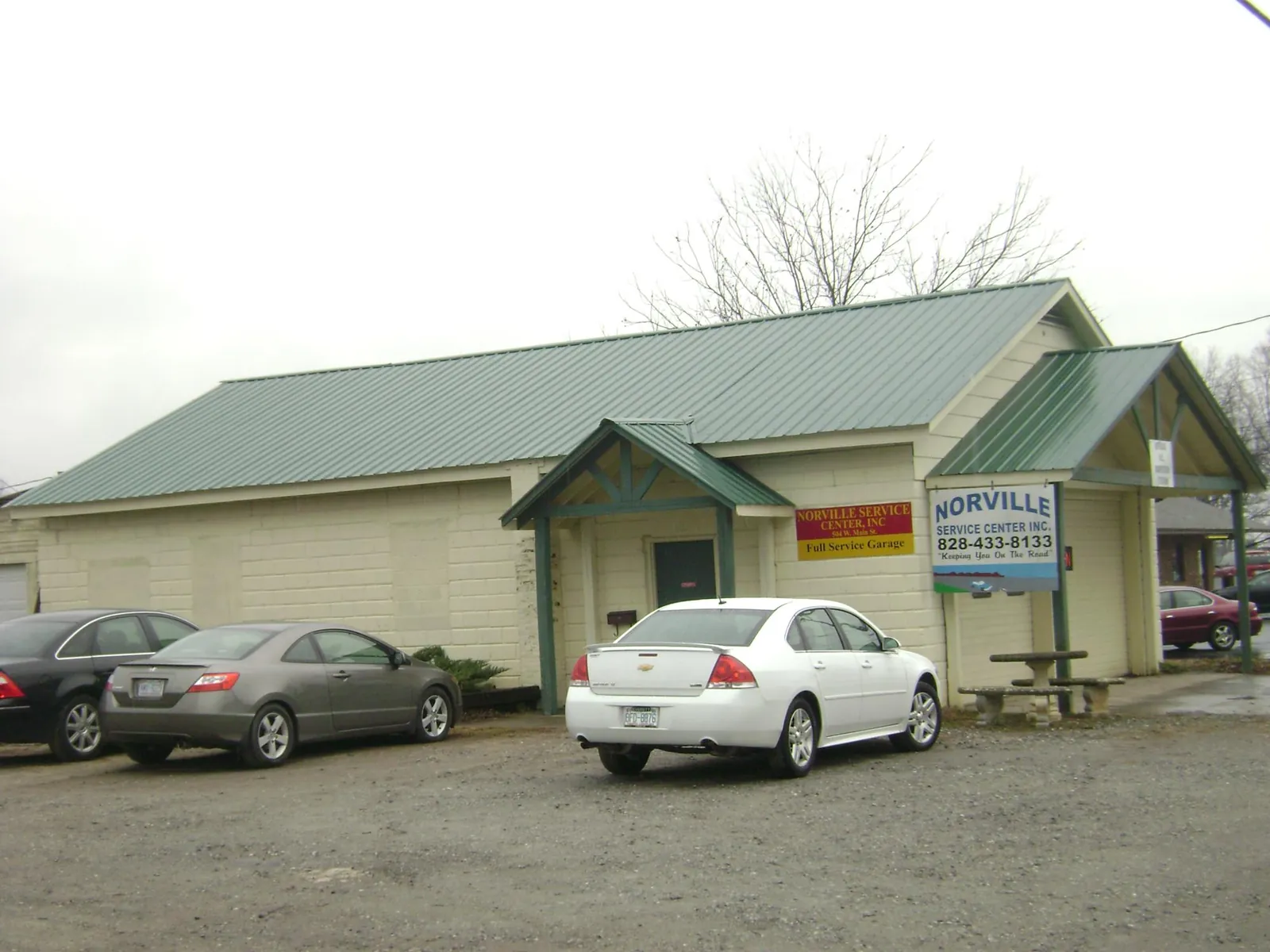 Green metal roof on a service garage with a covered entry in Robbins